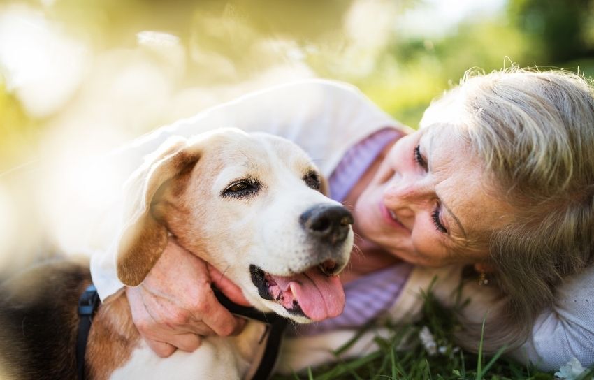 Senior woman embracing her dog